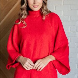 JODIFL striking red oversized turtleneck with a soft texture.